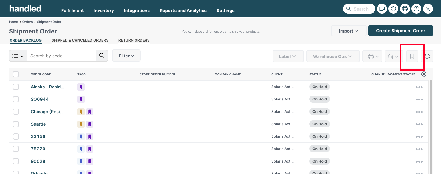 Handled Shipment Order list with the tag button highlighted in the toolbar
